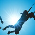 Two people on a trapeze showing the importance of trust