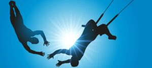 Two people on a trapeze showing the importance of trust