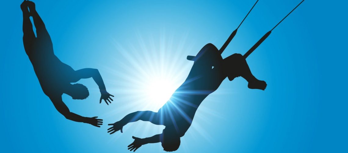 Two people on a trapeze showing the importance of trust